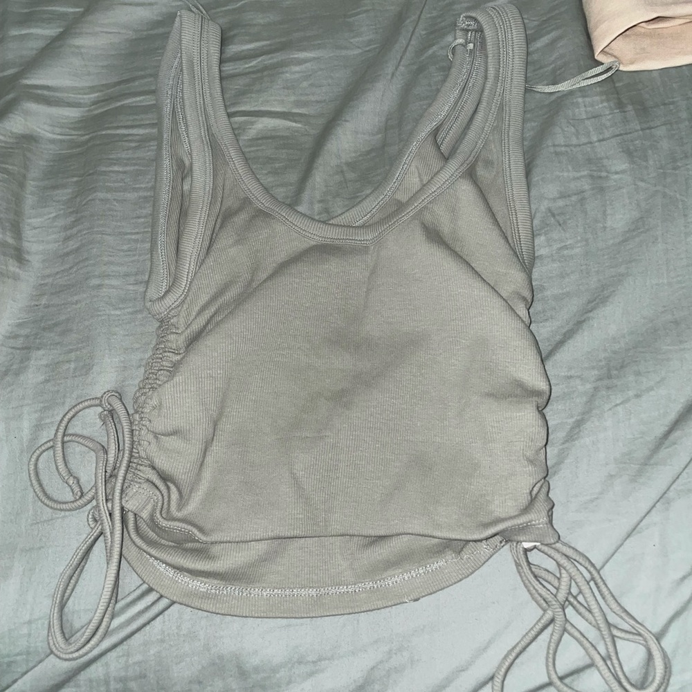 Crop top with tie details on the back. NEVER WORN